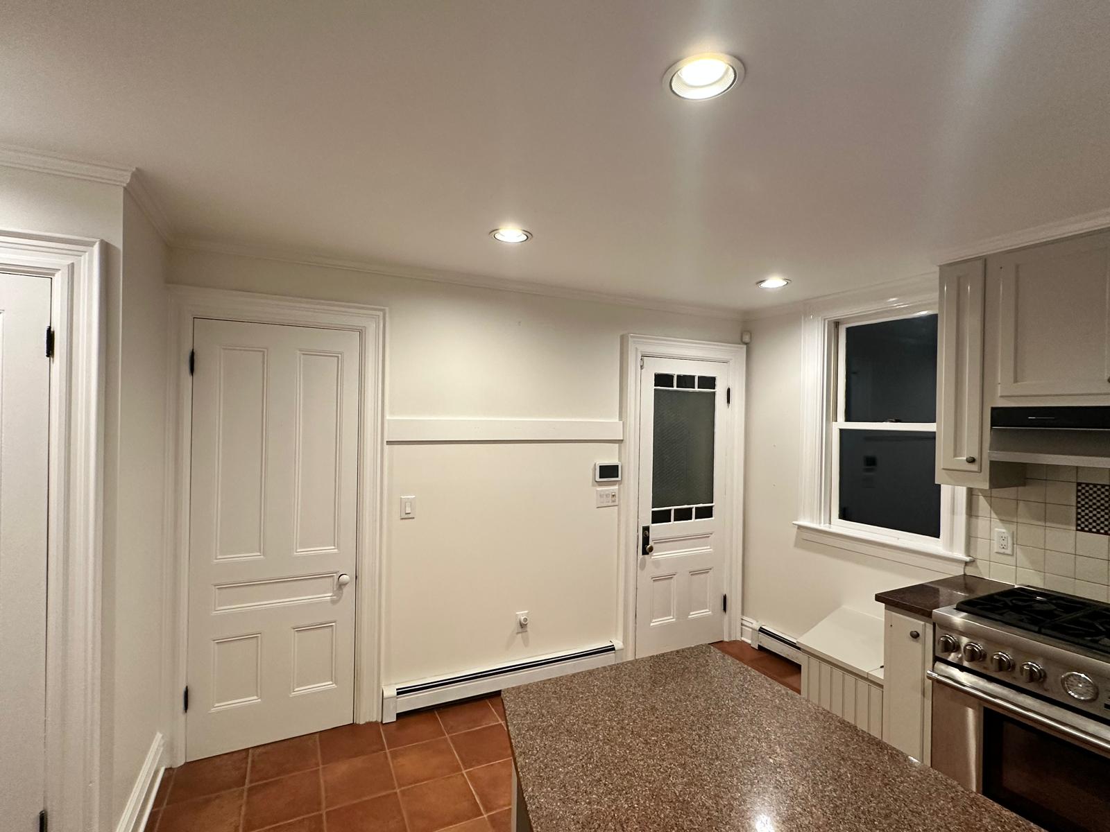 Bright painted kitchen interior with white cabinets and trim